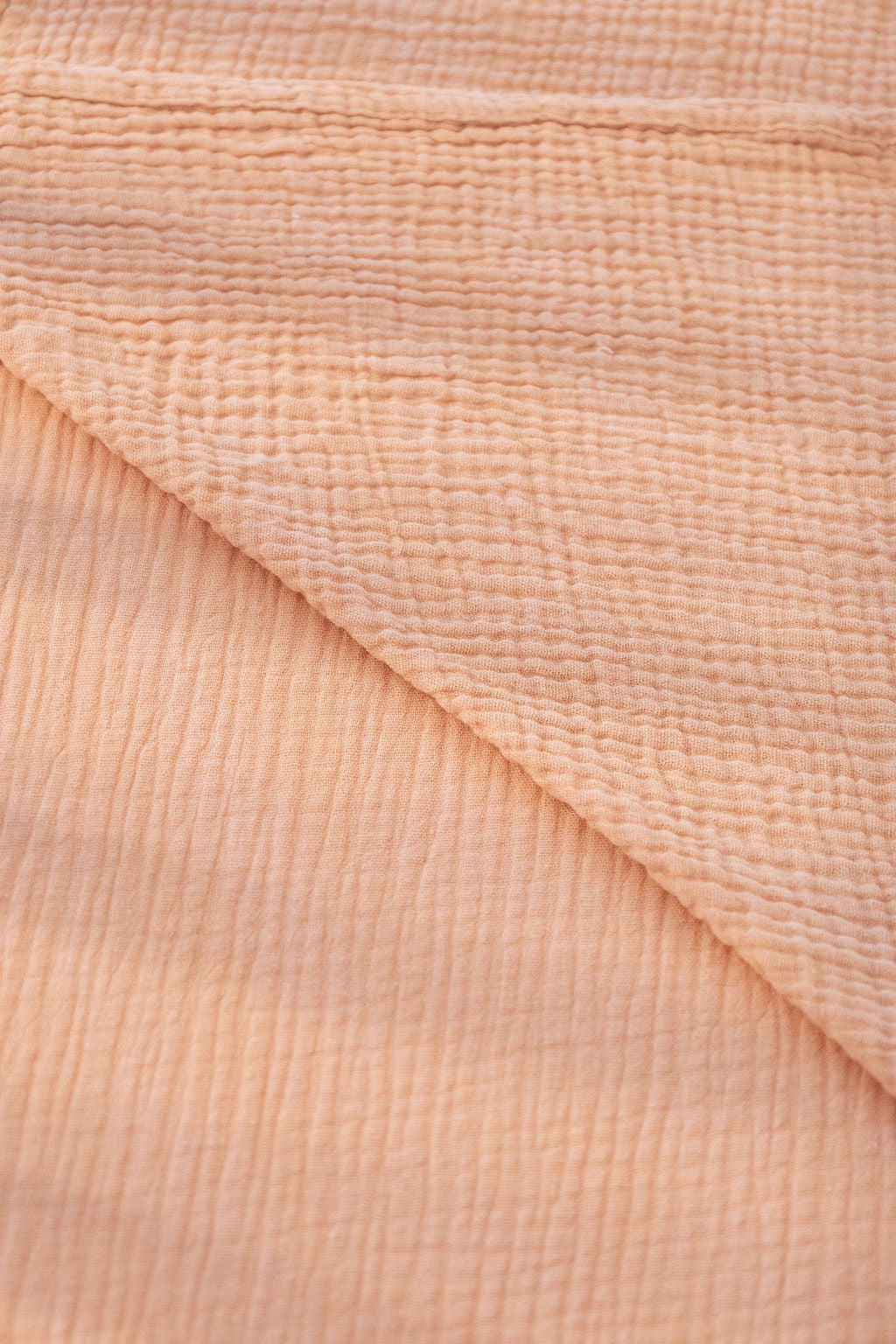 Close-up of beige fabric with a textured pattern