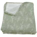 Green blanket with white leaf pattern on a white background